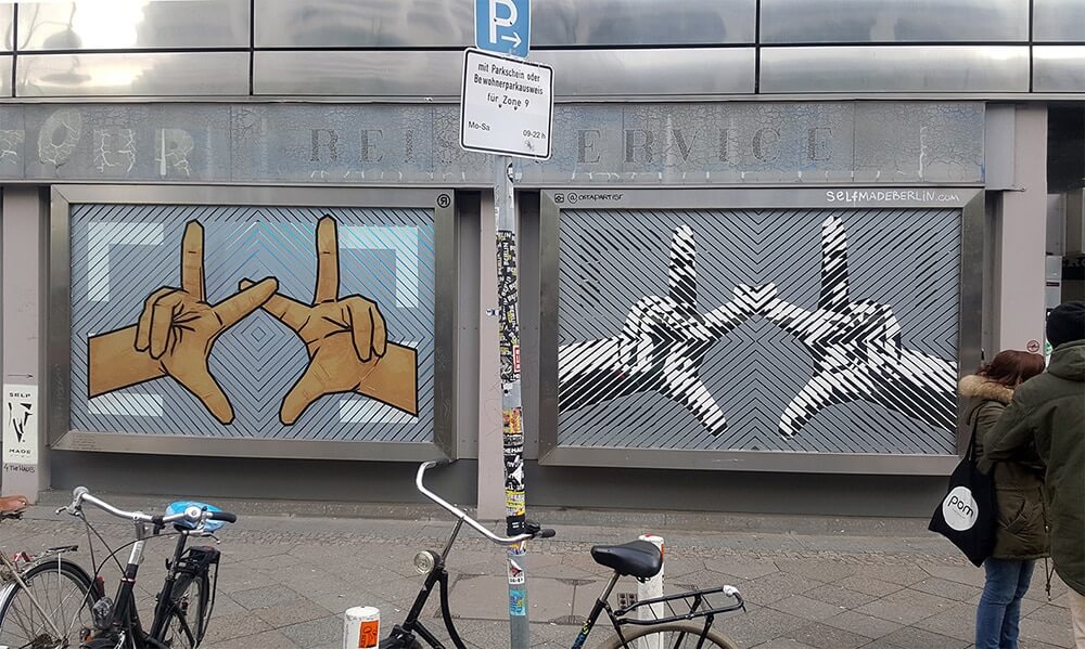 Two street art pieces- The Haus Berlin Art Bang- Logo- live tape art by Selfmadecrew- Panorama image