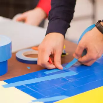 Workshop Participant Hands and Tape Rolls
