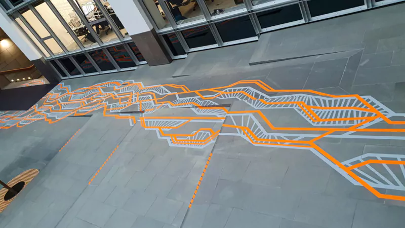 Wayfinding guidance on the ground in hapag lloyd brand colours