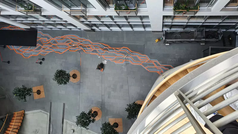 Abstract guidelines on the ground in Hapag Lloyd brand colours at the company headquarters